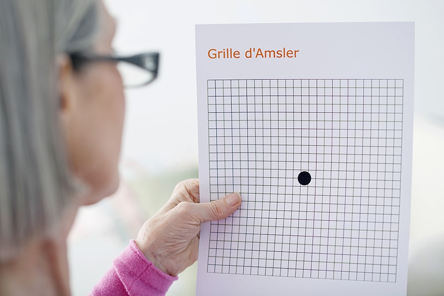 AMD Screening woman looking at an Amsler Grid