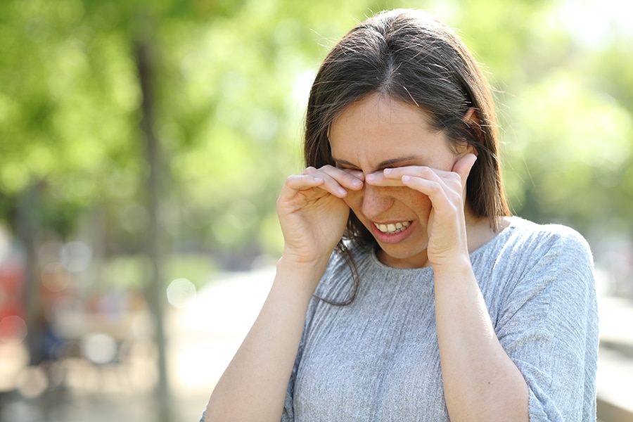 Woman rubbing her irritated eyes